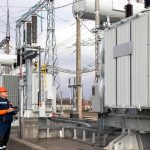 Utility engineer inspecting high-voltage electrical infrastructure